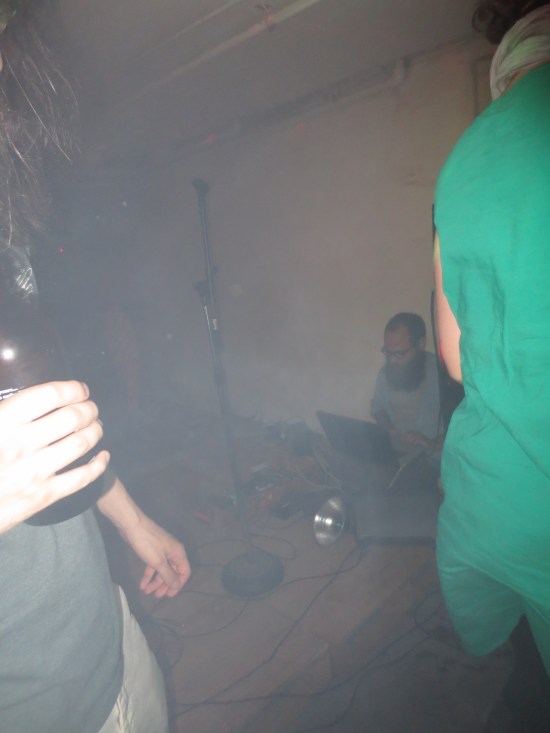 OCDJ chilling in a corner playing tracks off his laptop while everyone dances